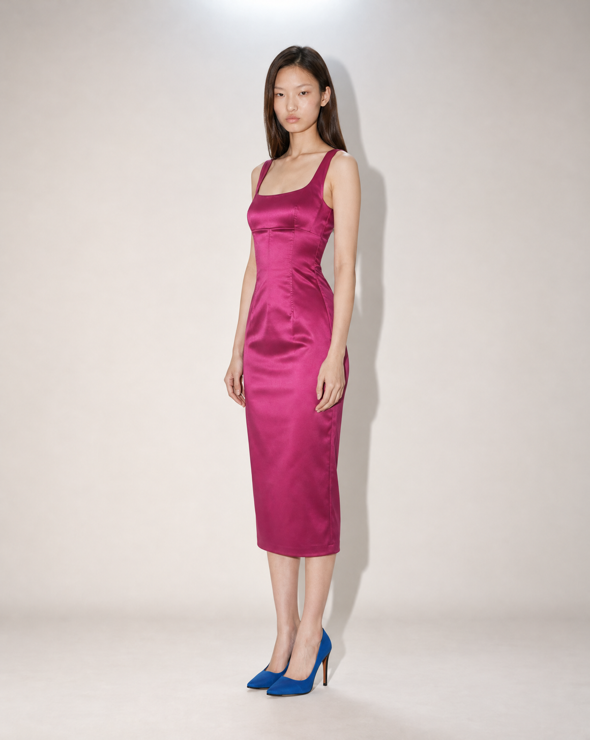 Shop this late 1990s Dolce & Gabbana fuchsia satin dress at Mezzanotte Vintage. The sculpted midi sheath silhouette and clean tailoring make it a distinctive collectible designer piece.