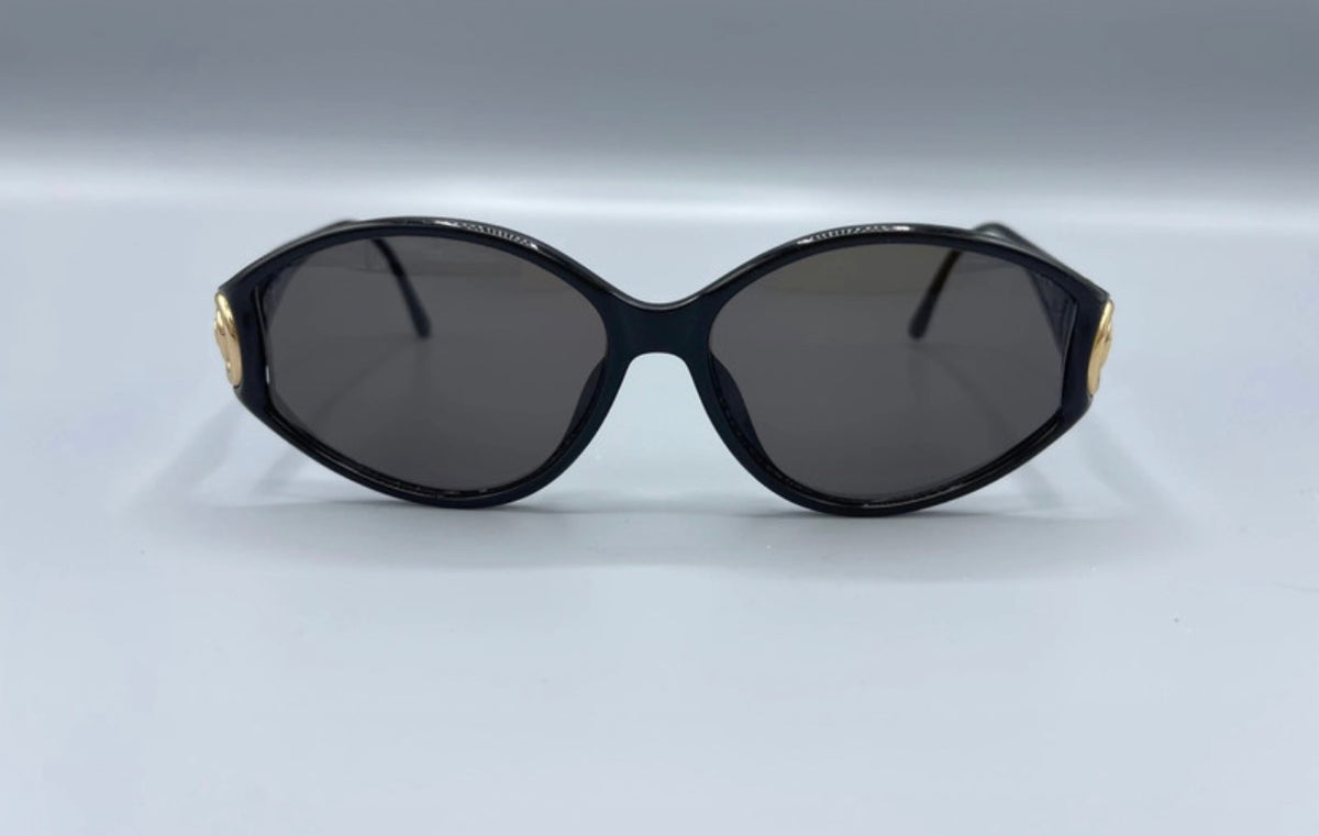Vintage Dior 1990s horizontal oval sunglasses styled on a model wearing a white tank top.