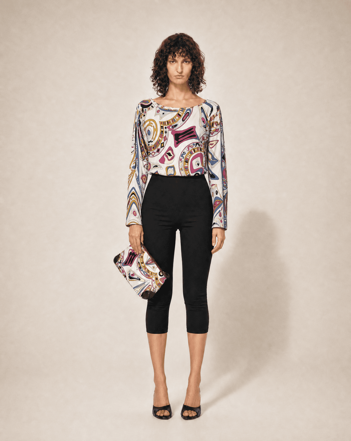 Rare Emilio Pucci 1990s silk jersey top styled with the matching print clutch. Rent in Madrid or buy across Europe at Mezzanotte.