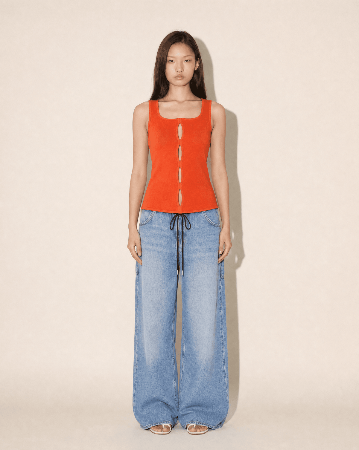 Gianni Versace 1990s coral knit top with architectural cut-outs, available to rent in Madrid or buy across Europe at Mezzanotte.