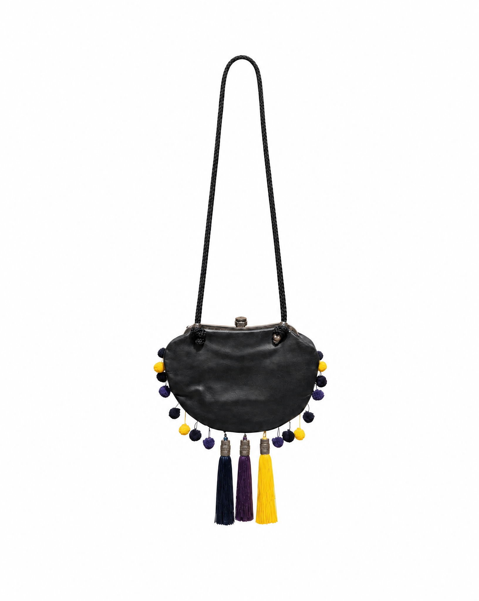 Detail view of the handcrafted tassel and pom-pom detailing on an archival 2007 Galliano bag curated by Mezzanotte.