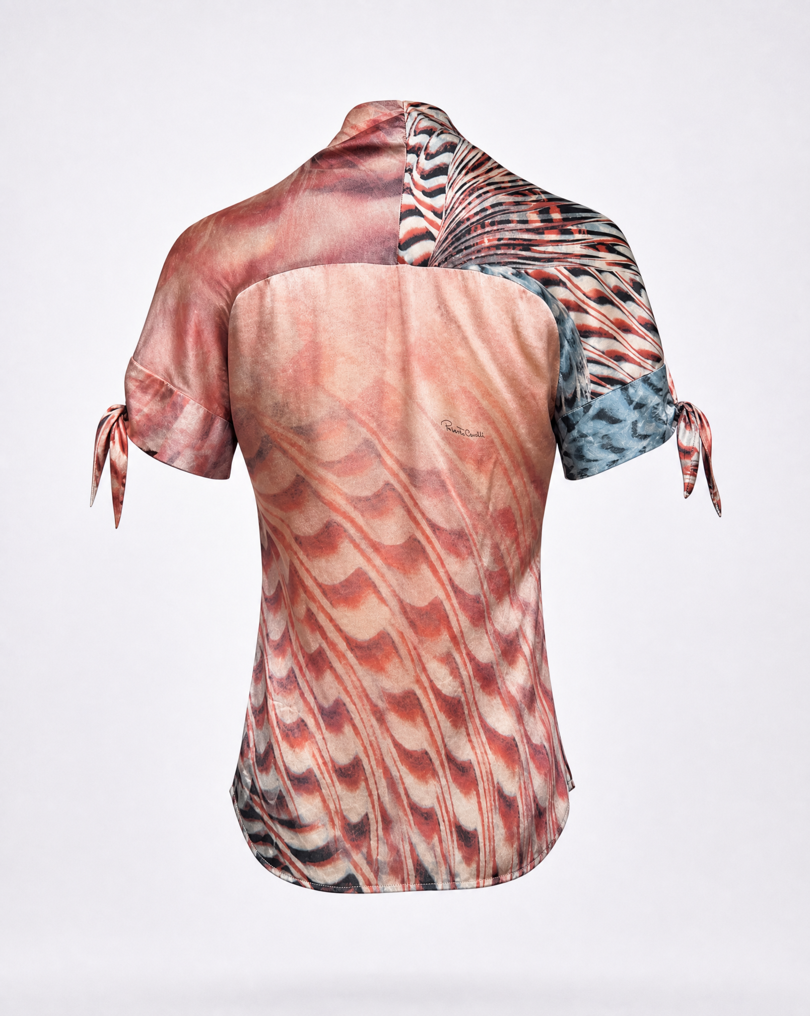 Detail of the signature Roberto Cavalli abstract animal-inspired print in red, ivory and charcoal on sheer silk.
