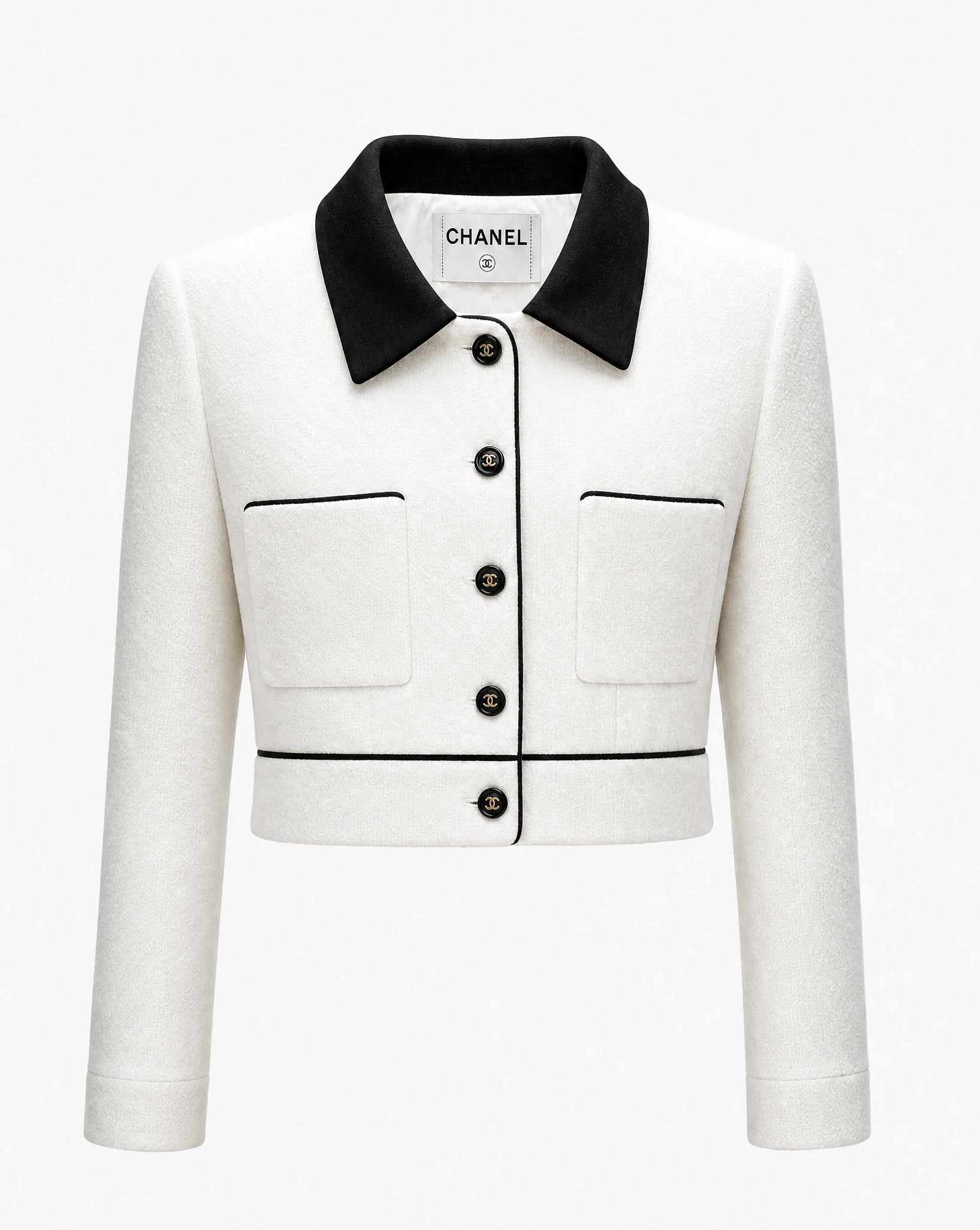 Detail view of CC buttons on a vintage Chanel jacket curated by Mezzanotte.