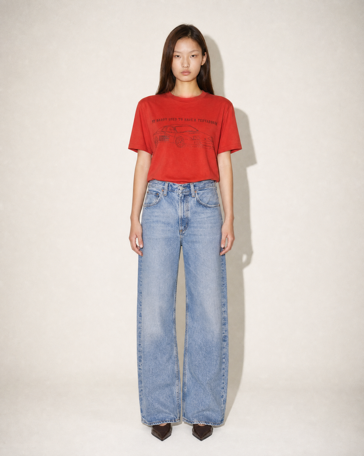 Vintage Ferrari Testarossa red graphic T-shirt styled with wide-leg blue denim at Mezzanotte.