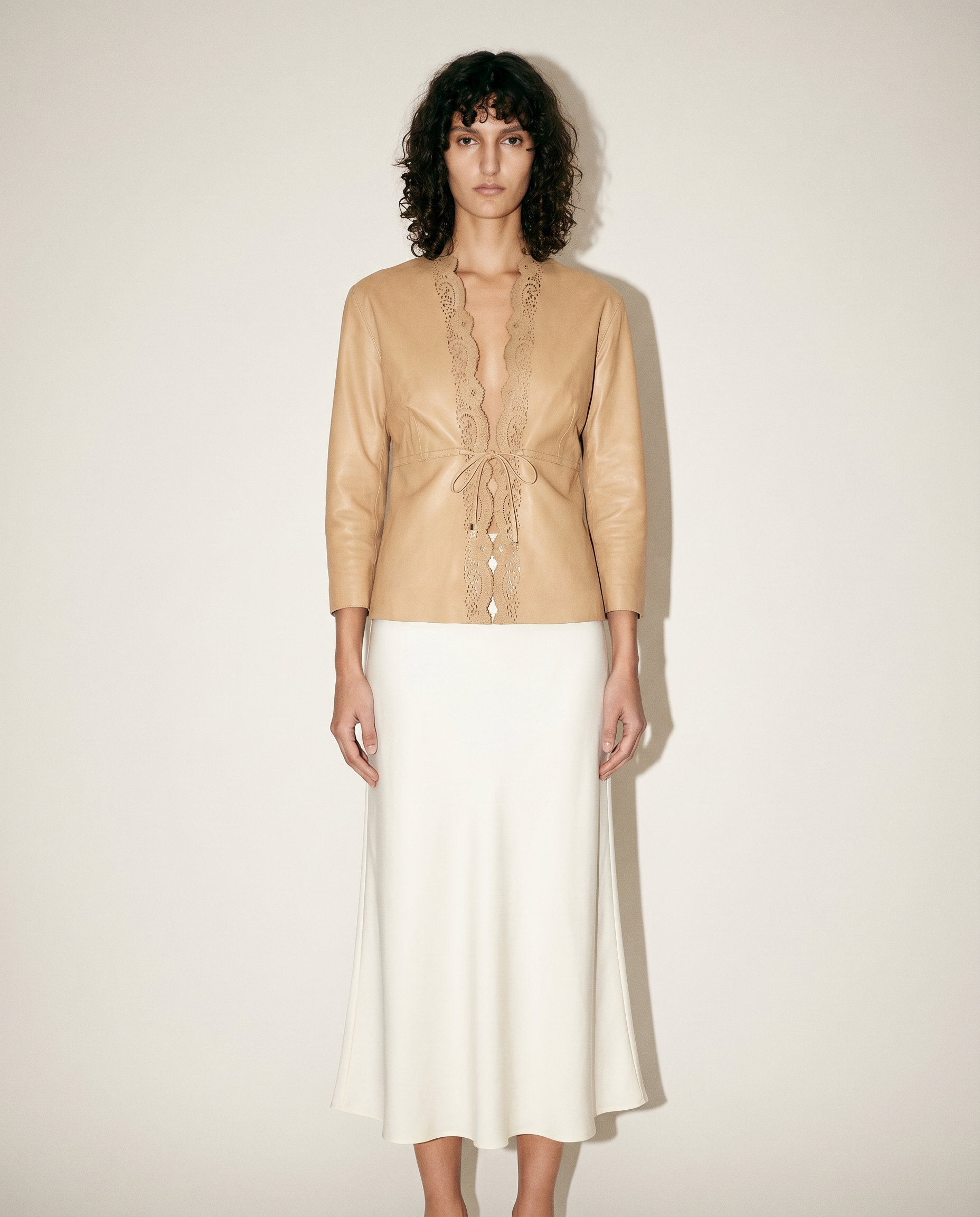 Vintage Gucci by Tom Ford nude leather tie-front jacket with intricate laser-cut detailing, available for purchase and luxury rental across Europe from Mezzanotte.
