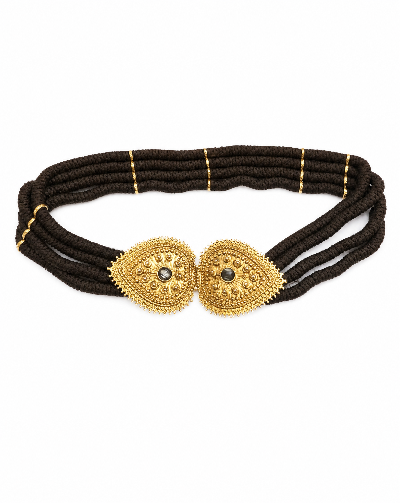 Detail view of the intricate gold-tone filigree buckle on an archival YSL belt curated by Mezzanotte.